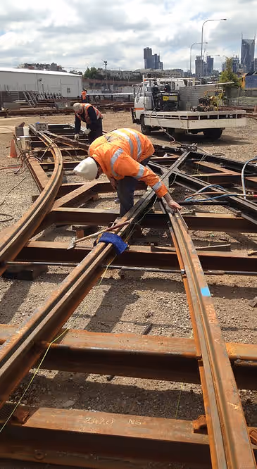 A welder working at the rail head.