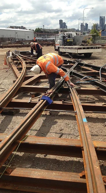 A welder working at the rail head.